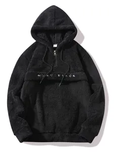 Detail of a black plush hoodie for men featuring half-zip and Muscletack embroidery on chest.