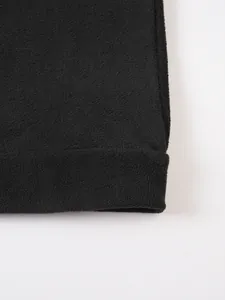 Macro view showing the soft fleece fabric texture of the black slim sweatshirt.