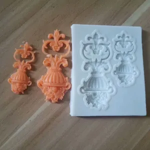 Detailed view showing European relief flower pot silicone mold with orange resin flower casts