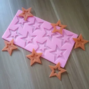 Close-up detail of a pink 8-cavity star silicone mold for DIY baking and chocolate