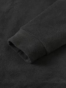 Detailed close-up of the elastic cuff and soft fleece texture of the black men's sweatshirt.