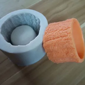 Detailed view of DIY tree stump silicone mold with an orange resin flowerpot casting