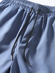 Detail shot of men's blue casual cargo pants with elastic waistband and drawstring