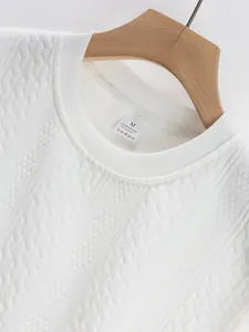 Close-up of white jacquard knit sweatshirt neckline featuring clear size label details