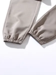 Detailed macro shot of the elasticated ankle cuffs on durable khaki cotton jogger pants