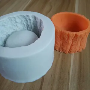 Close-up of silicone tree stump flower pot mold and orange textured sample