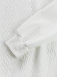 Close-up of white jacquard fabric texture and ribbed cuff on men's sweatshirt