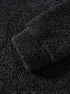 Detailed close-up of black sherpa fleece jacket sleeve cuff showing soft texture