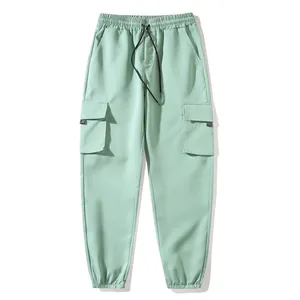 Mint green cargo joggers featuring a drawstring elastic waist and side flap pockets