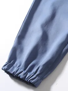 Detailed view of elastic gathered cuff on blue retro casual cargo pants for men