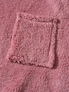 Macro detail showing the soft pink fuzzy fleece fabric and square pocket texture