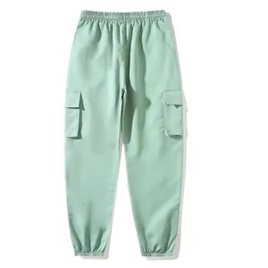 Front view of light green cargo joggers featuring elastic waist and side flap pockets.