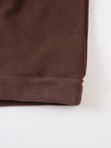 Close-up macro detail of soft brown fleece fabric on men's casual sweatshirt sleeve