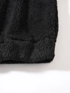 Macro detail of black sherpa fleece texture on mens winter hoodie hem