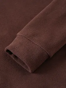 Detail view of brown fleece sweatshirt showing soft cuff and premium fabric texture.