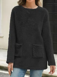 Close-up of a cozy black fuzzy long-sleeve sweatshirt with dual pockets for women.