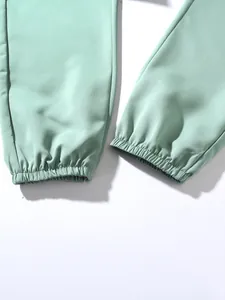 Close-up of elastic leg cuffs on mint green cotton jogger pants