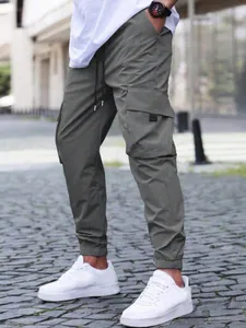 Detailed view of men's olive green cargo joggers with elastic drawstring waist and cuffs