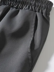 Close-up detail of men's cargo pants showing elastic waistband and pocket texture