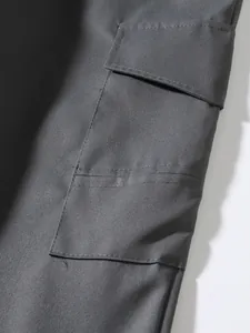 Close-up of charcoal gray cargo pants pocket showing durable twill fabric and stitching