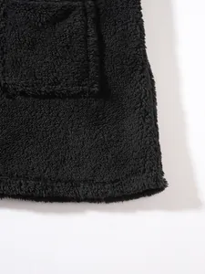 Detail view of premium black fleece sweatshirt fabric showing pocket and hem texture