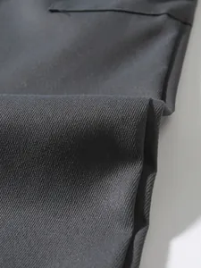 Close-up of heavy-duty black twill fabric texture on men's cargo pants