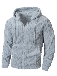 Gedetailleerd macrozicht van de getextureerde pluizige kabelgebreide stof op blauwe hoodie