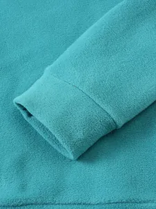 Close-up detail of soft turquoise fleece sweatshirt sleeve cuff and stitching