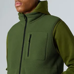 Close-up of green polar fleece outdoor vest with stand collar and zipper pocket
