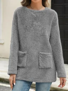 Detail shot of a grey loose-fit long sleeve fleece sweatshirt with front pockets for women.