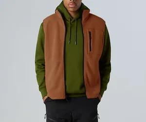 Detailed view of brown fleece vest featuring zipper pocket and stand collar design