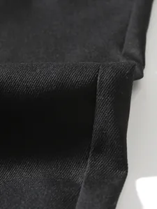 Detailed macro shot of the durable black twill fabric texture of men cargo pants