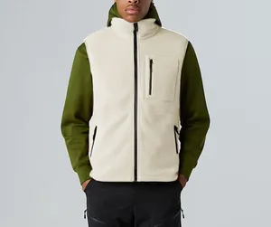 Detail view of a cream fleece outdoor vest with stand collar and zip pockets