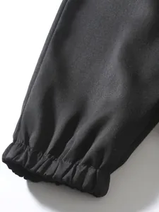 Detailed macro view showing the elasticated leg cuff of men's black heavy twill cargo pants