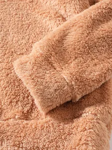 Macro view of soft camel teddy fleece texture and cuff detail on men's winter jacket