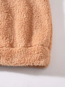 Detailed macro view of soft brown teddy fleece material on men's autumn winter jacket