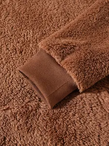 Close-up detail shot of the ribbed sleeve cuff on a brown sherpa fleece men hoodie