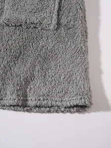 Detailed close-up showing the soft grey plush fleece fabric texture of a casual sweatshirt