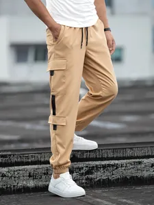 Close-up detail of khaki men's retro cargo joggers featuring multi-pockets and tapered fit