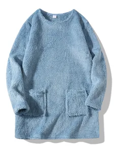 Detailed macro view of soft blue plush fabric and front pockets on casual sweatshirt