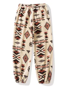 Detailed view of tribal geometric pattern fleece jogger pants with elastic cuffs