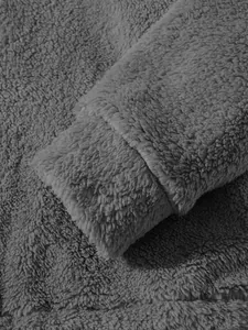 Close-up detail of grey fuzzy plush men's hoodie showing soft texture and sleeve cuff