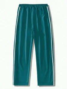 Front view detail of men's retro teal tracksuit pants with white side stripes