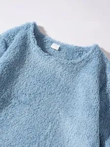 Close-up detail of light blue plush crewneck sweatshirt neckline and soft fuzzy fabric