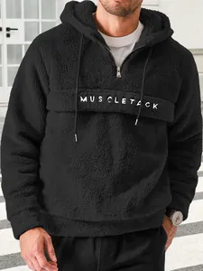 Men's black plush hooded pullover with quarter zip and Muscletack lettering