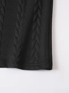 Macro view of textured jacquard fabric and double-stitched hem of black polo shirt
