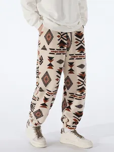 Close-up of men's fleece joggers with ethnic geometric print for winter warmth