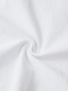 Macro shot of breathable white linen fabric showing fine texture and spiral fold details