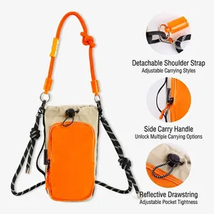Detailed view of outdoor crossbody bag with detachable straps and reflective drawstring