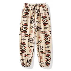 Warm fleece joggers with ethnic geometric patterns and an adjustable drawstring waist.